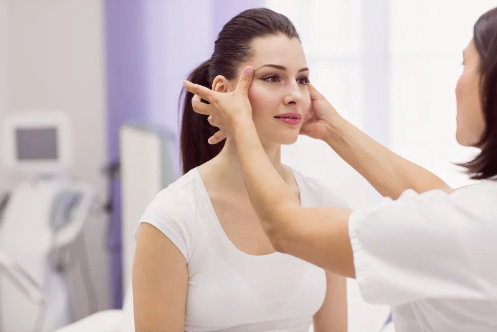 Clinician assessing facial balance during a dermal filler consultation