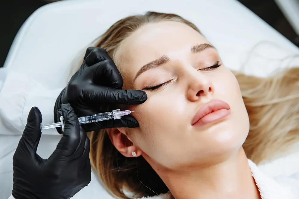 Cheek filler treatment performed in a clinical setting