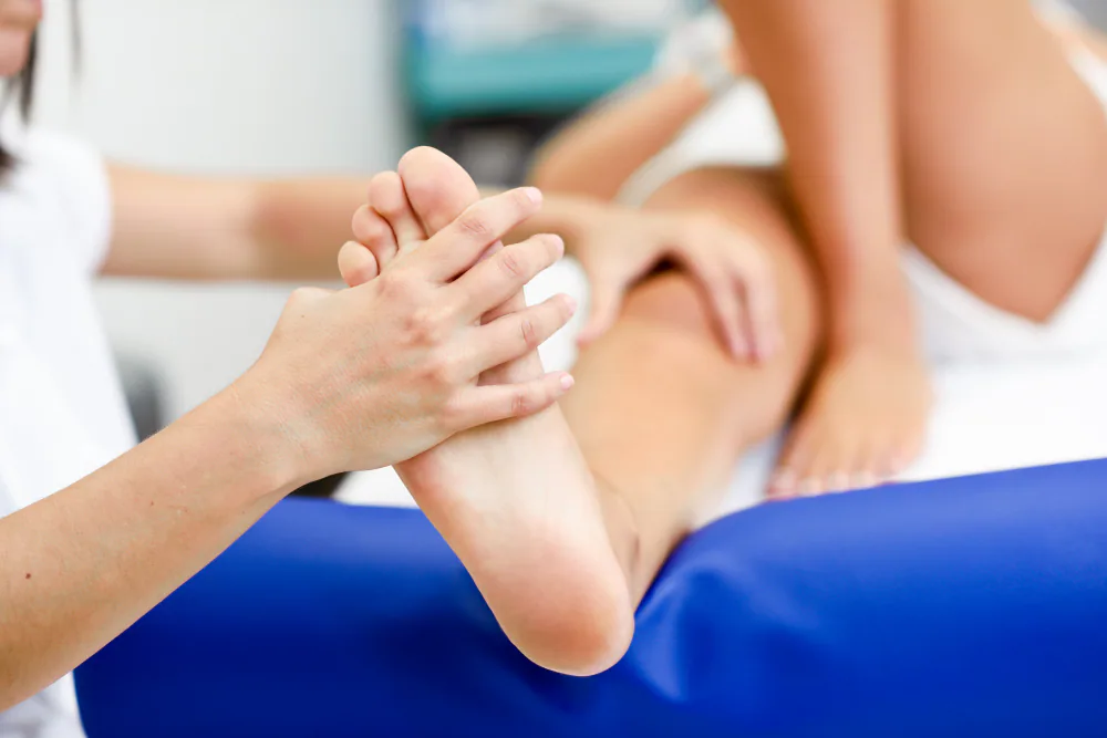 Clinician assessing the sole of the foot for plantar hyperhidrosis