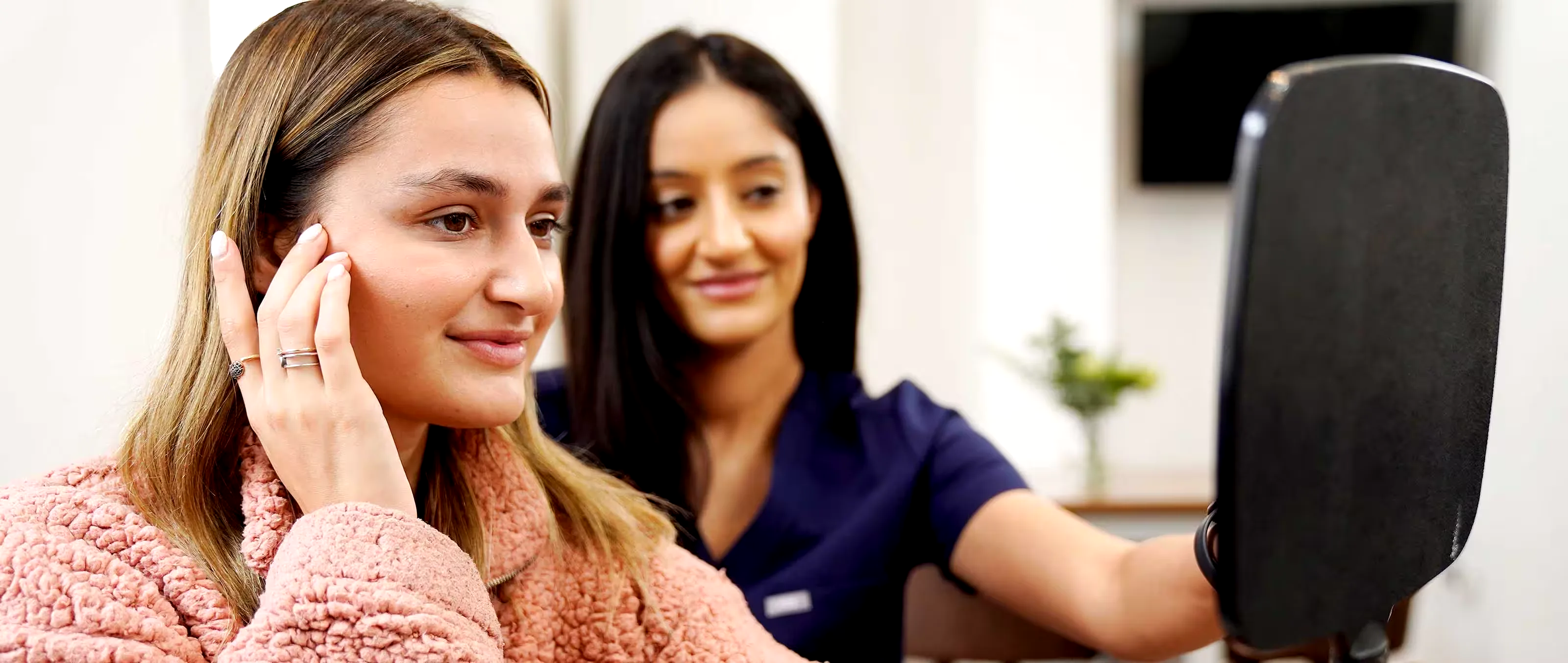 Patient discussing treatment progress with a clinician during a clinic visit