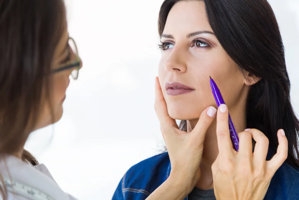 Clinician assessing facial balance for a full-face Botox consultation