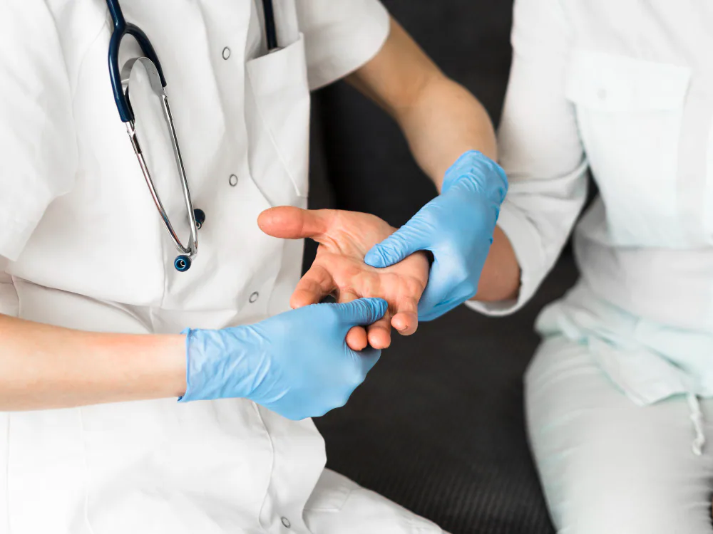 Clinician assessing a patient palm for hand hyperhidrosis treatment